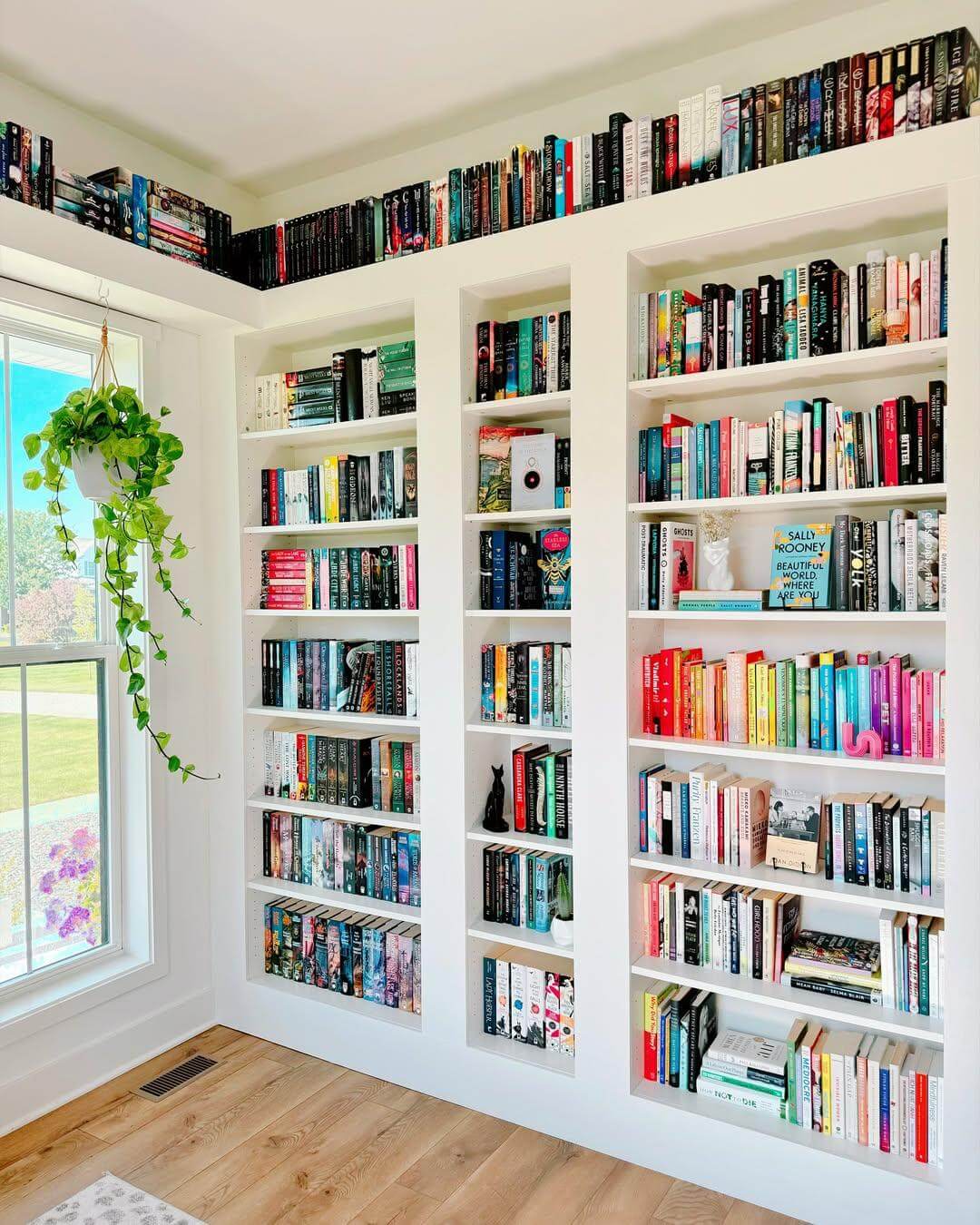 White Built-In Shelving Creates a Clean Backdrop for Colorful Books