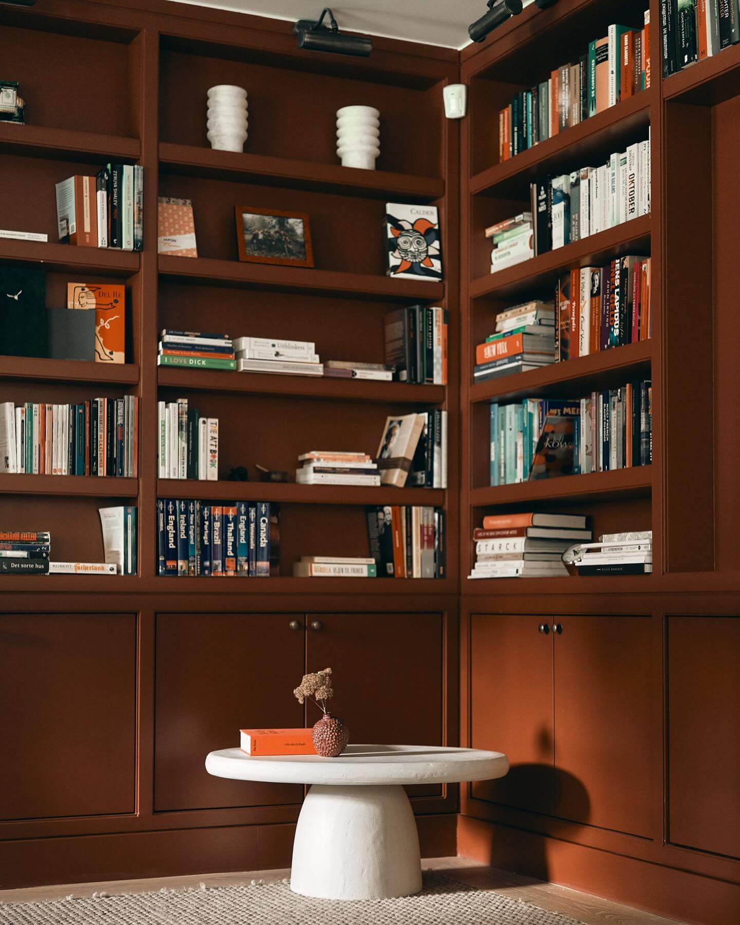 Conceal Clutter Below Your Books with Dark Wood Cabinets