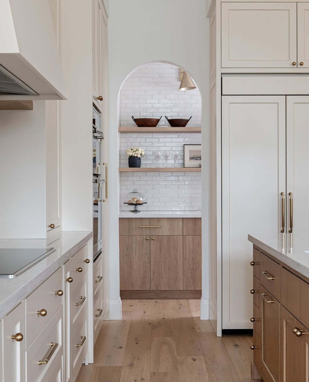 Frame Open Shelving with an Arched Entryway and Decorative Bowls
