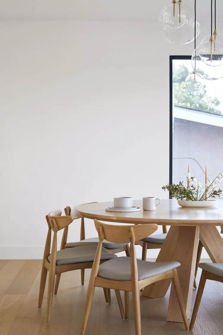 Select a Round Wood Dining Table with a Sculptural Base