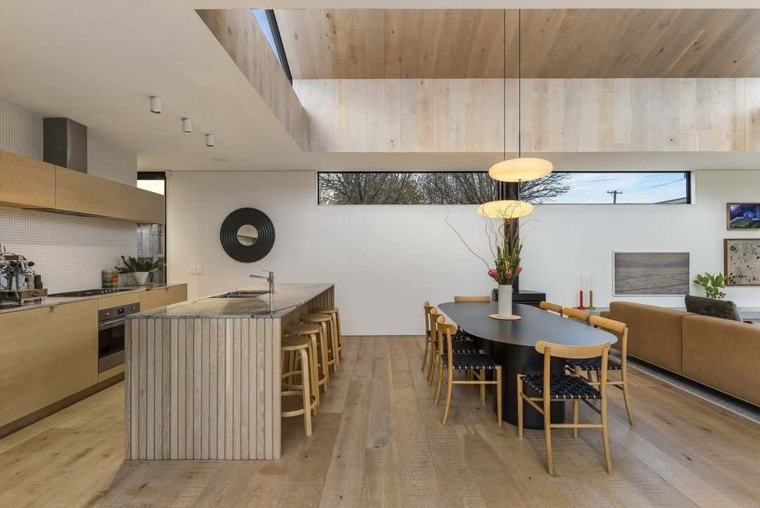 Achieve Minimalist Style with an Oval Table and Natural Chairs
