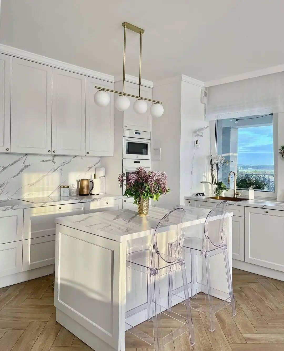Clear Bar Stools Create an Airy Feel Around the Island