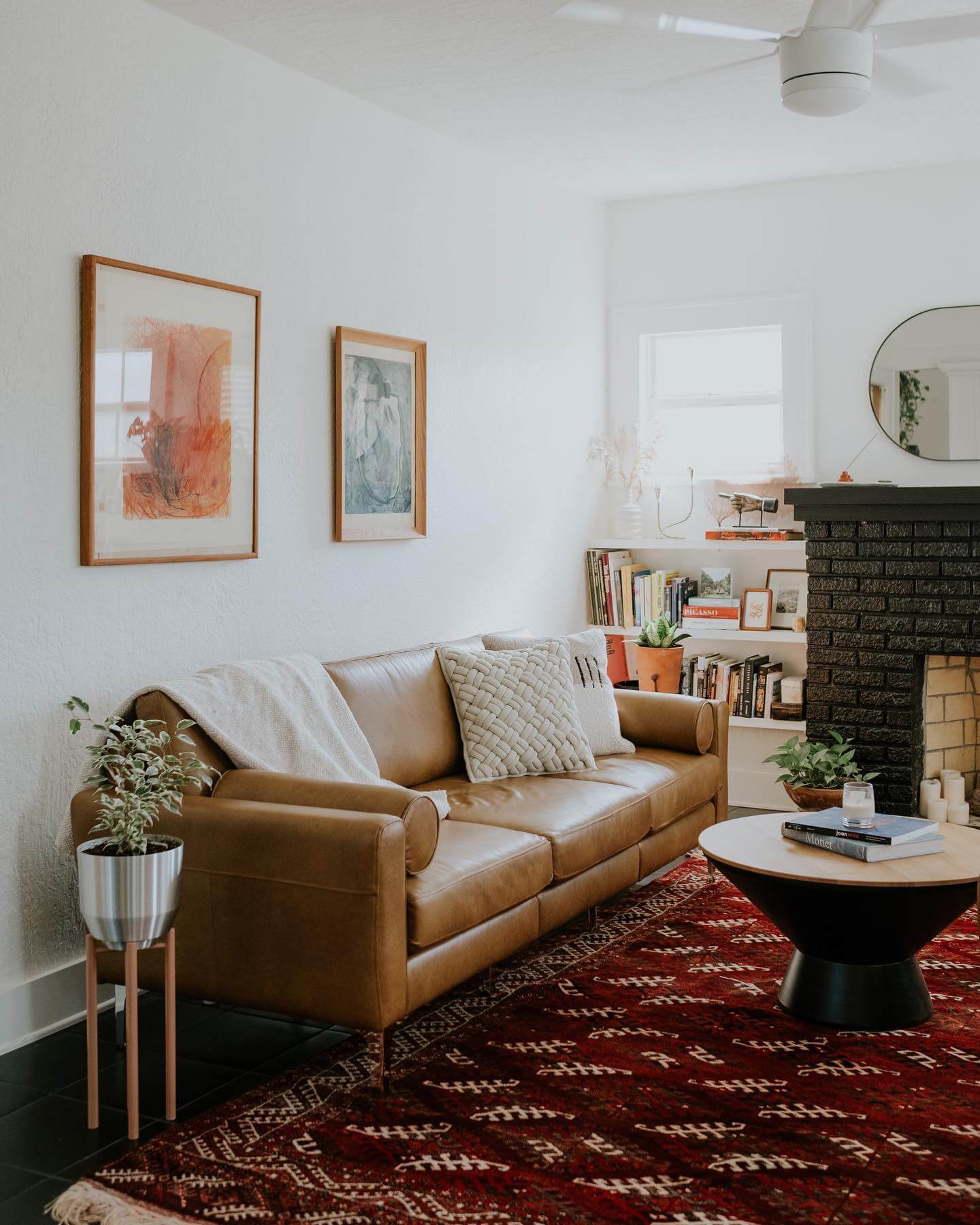 Framed abstract art adds warm color to a white wall