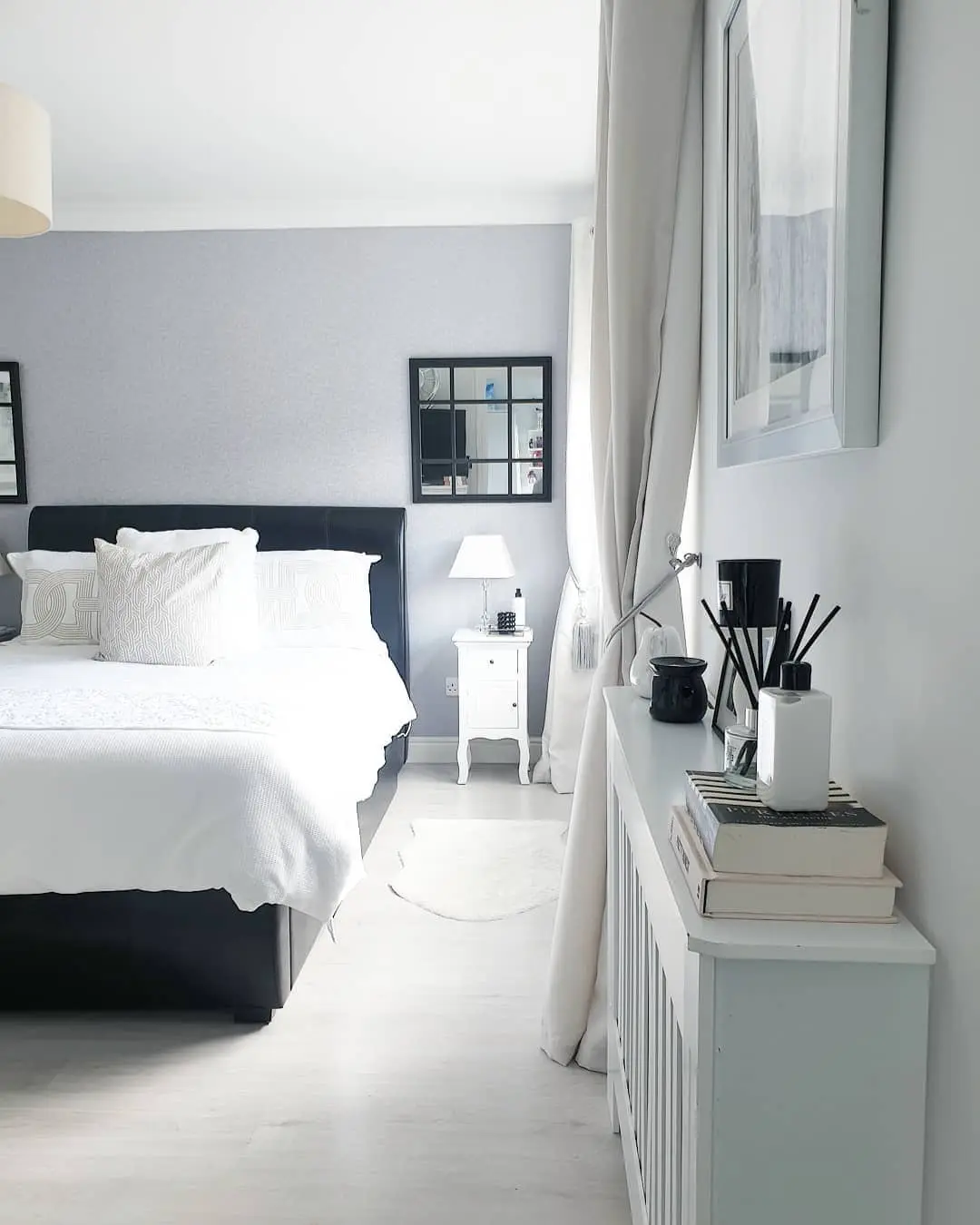 Black Grid Mirror Adds a Window-Like Accent Above the Nightstand