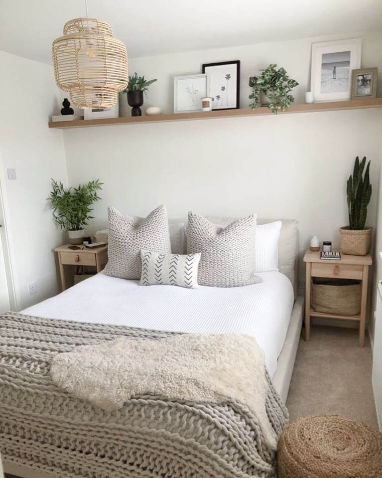 Narrow Wooden Shelf Displays Framed Art and Greenery