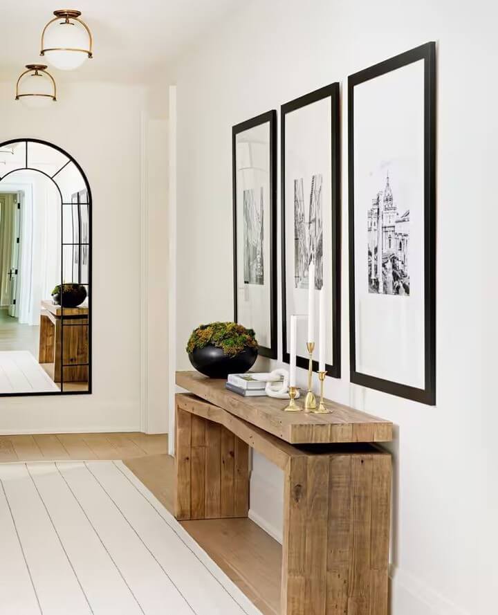 Three tall framed architectural prints create a striking vertical gallery wall