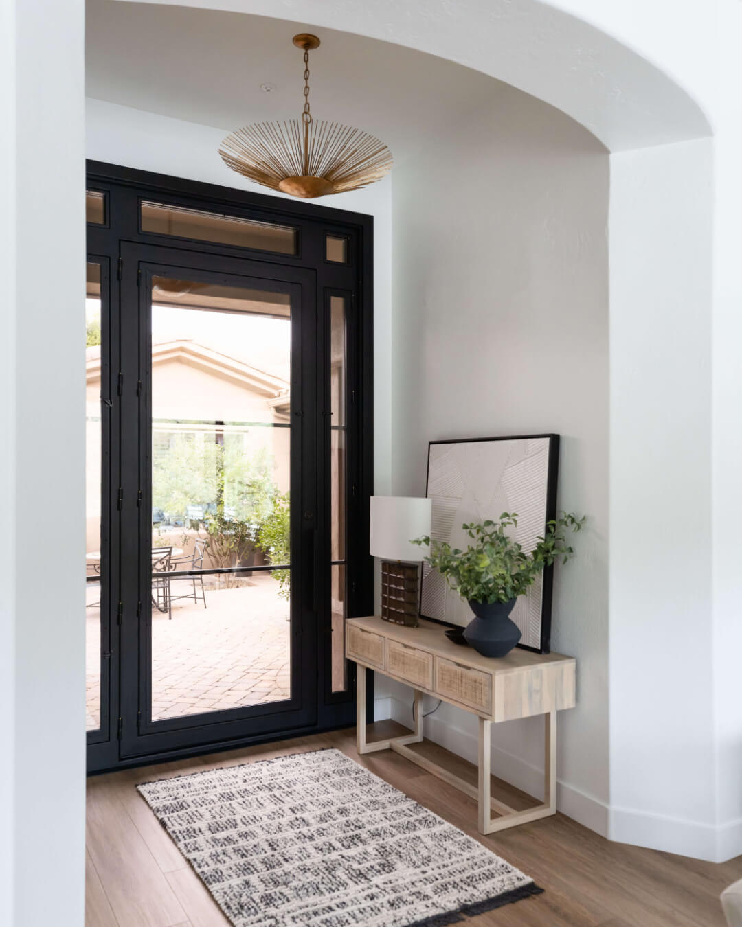 Geometric Artwork and Textured Lamp Create a Modern Vignette