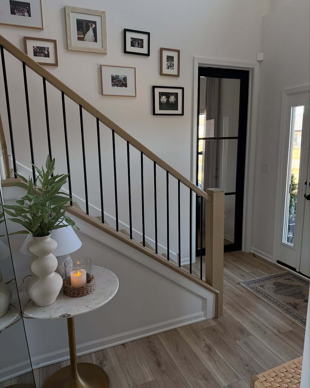 Gallery wall of framed family photos along the staircase