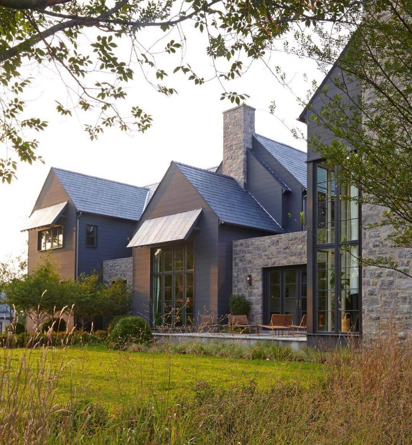Stone Facade Accents Dark Siding With Rustic Texture