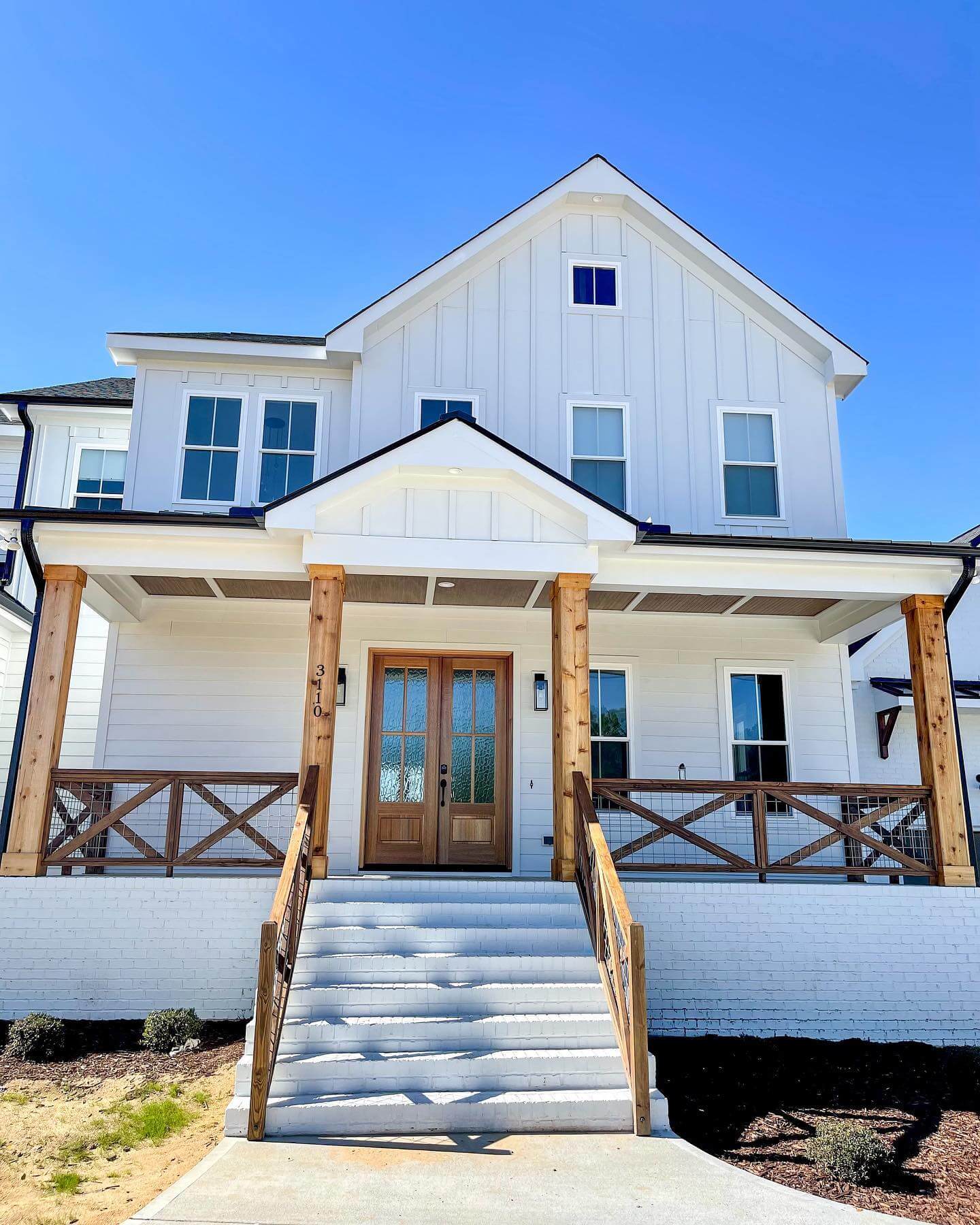 Wooden Entry Posts Frame a Modern Farmhouse Door