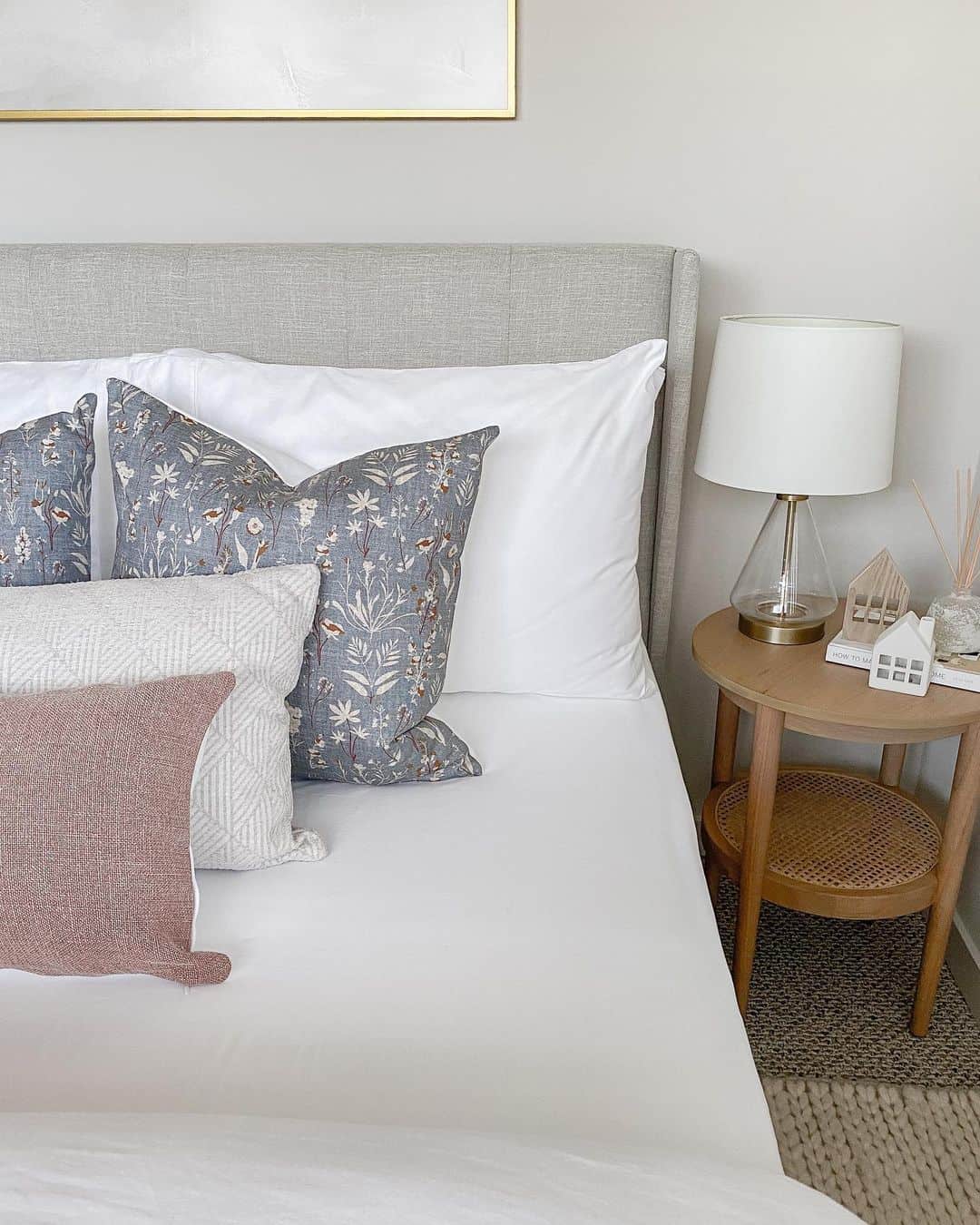 Floral and Geometric Pillows Layered on a Neutral Bed