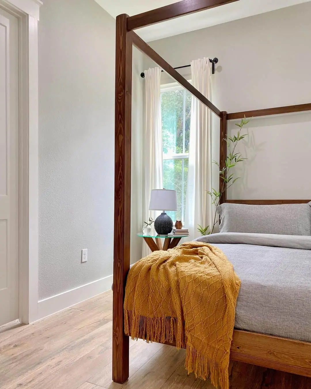 Dark Wood Four-Poster Bed Frames a Cozy Guest Retreat