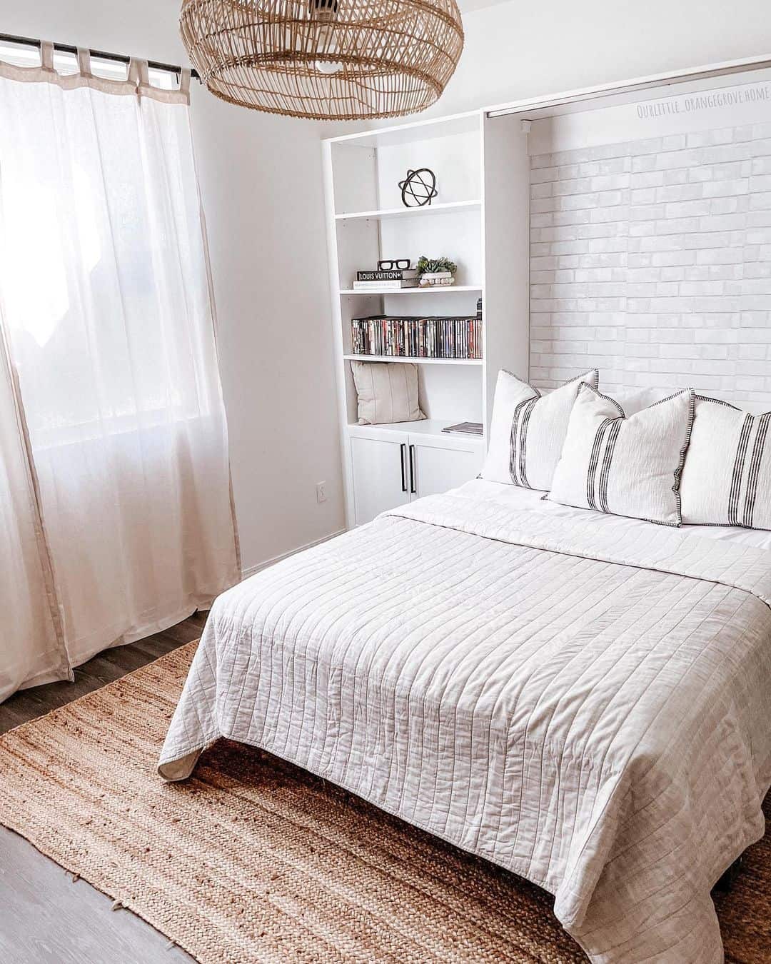 White Brick Wall Creates a Textured Backdrop for a Murphy Bed
