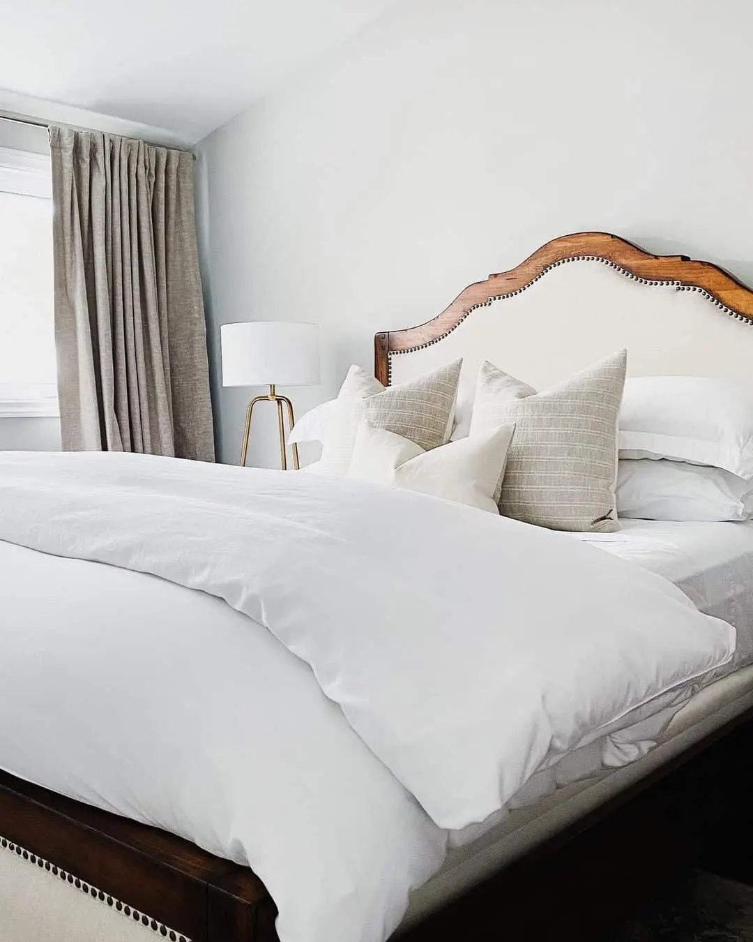 Curved Headboard With Nailhead Trim Adds Classic Detail
