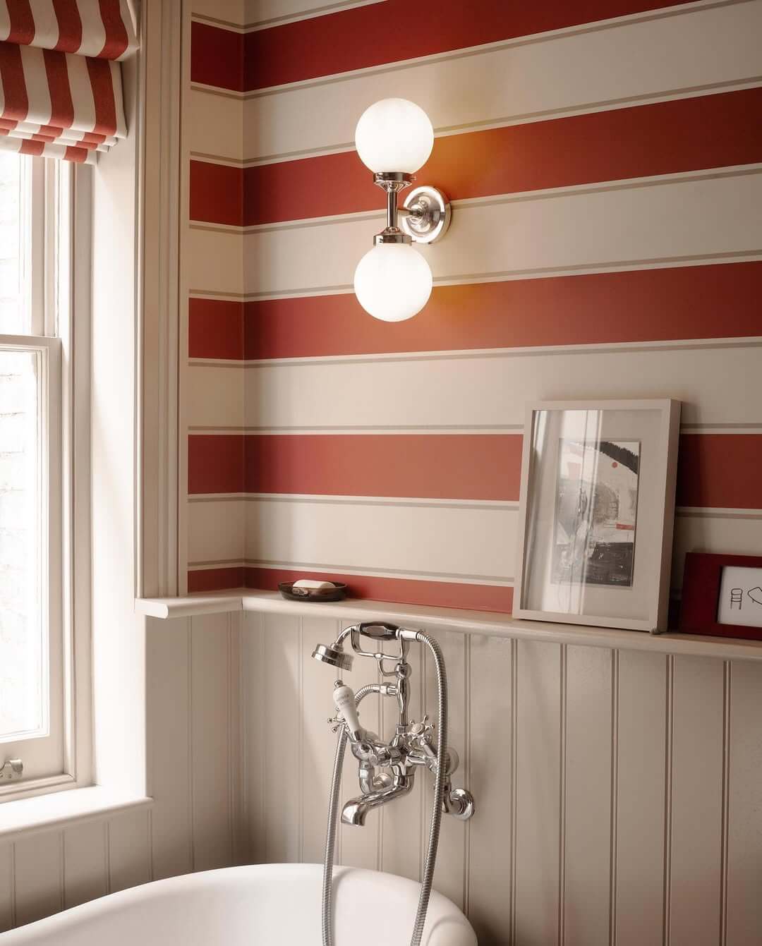 Double Globe Sconces Add Soft Illumination Above Striped Wallpaper