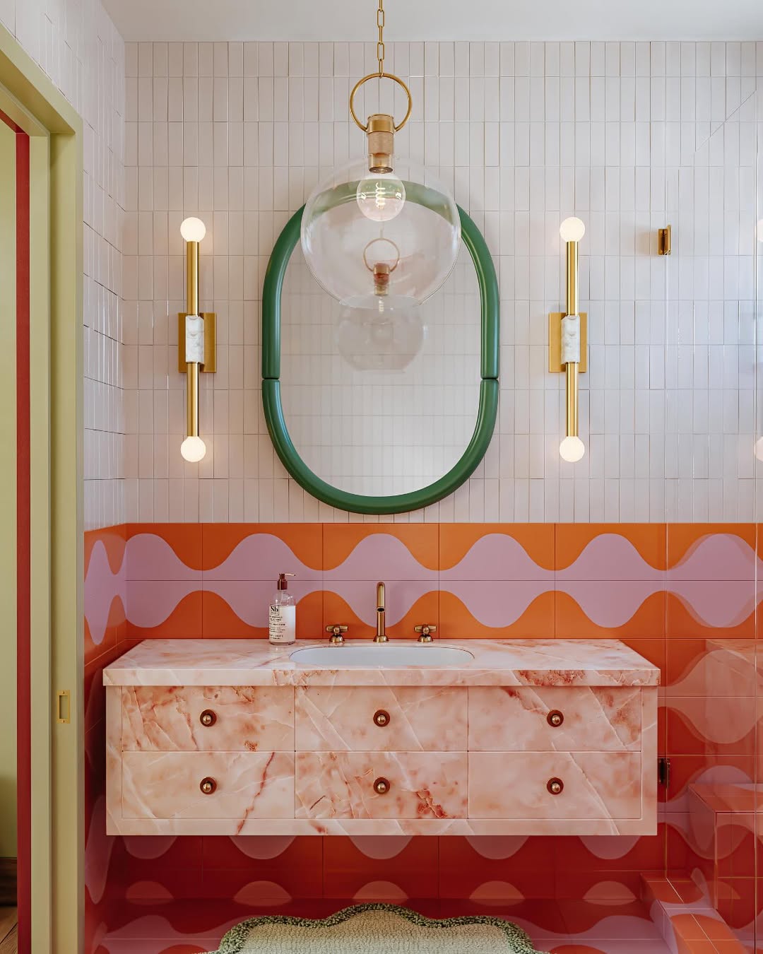 Green-Framed Oval Mirror Anchors a Playful Wavy Tile Backsplash