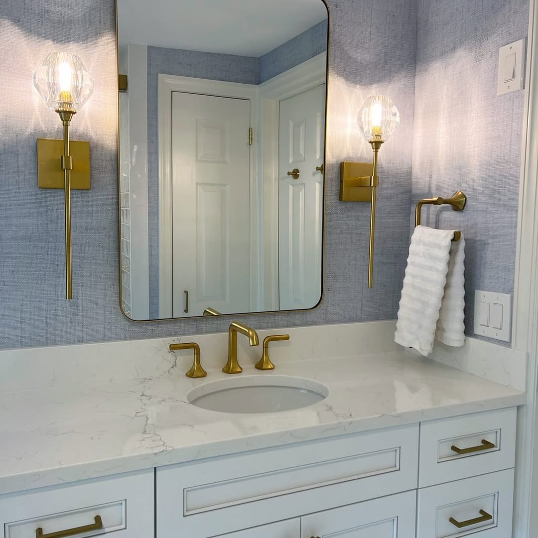 Glass Globe Sconces With Brass Arms Add Warm, Textured Light
