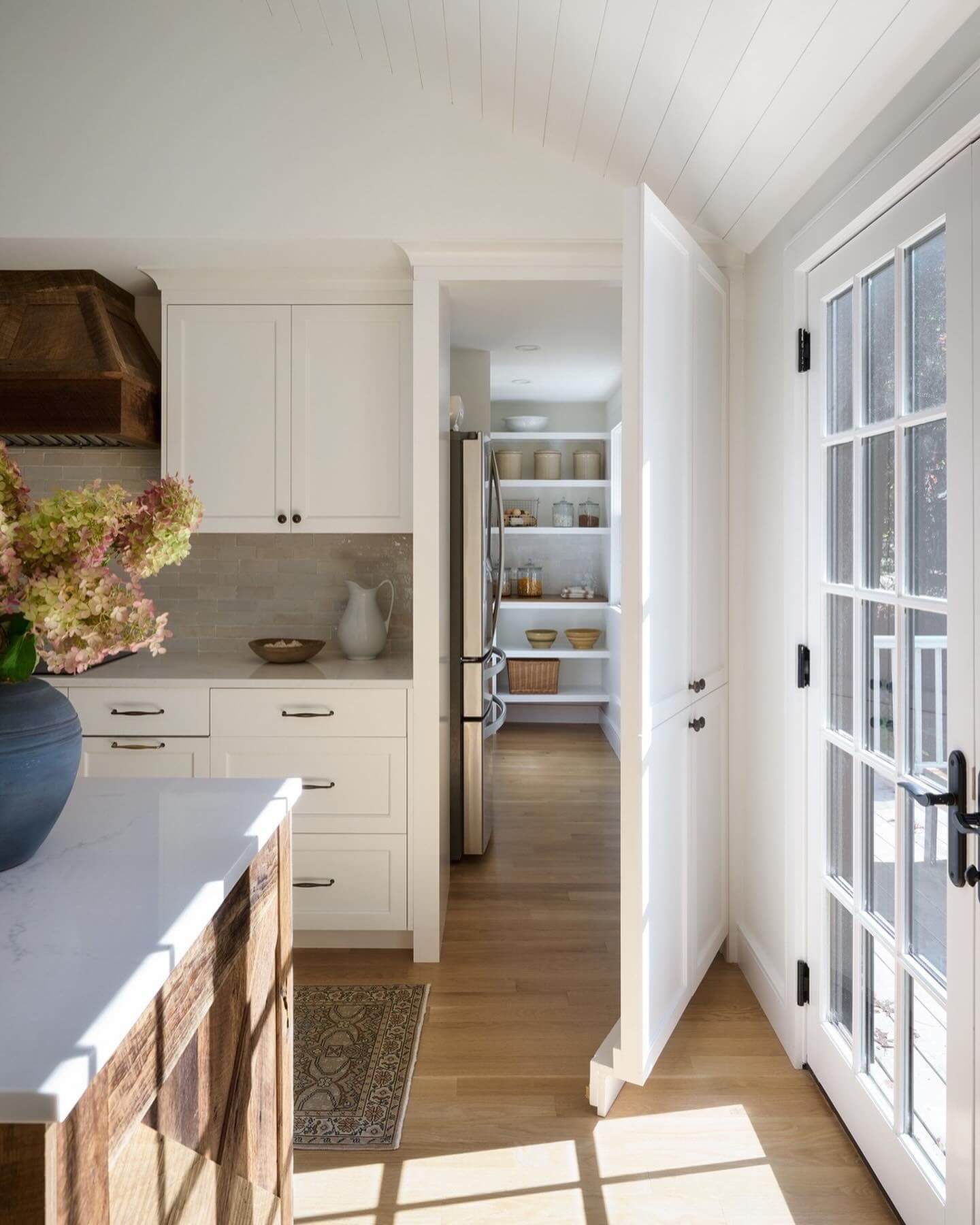 Open pantry shelves with a variety of jars and baskets