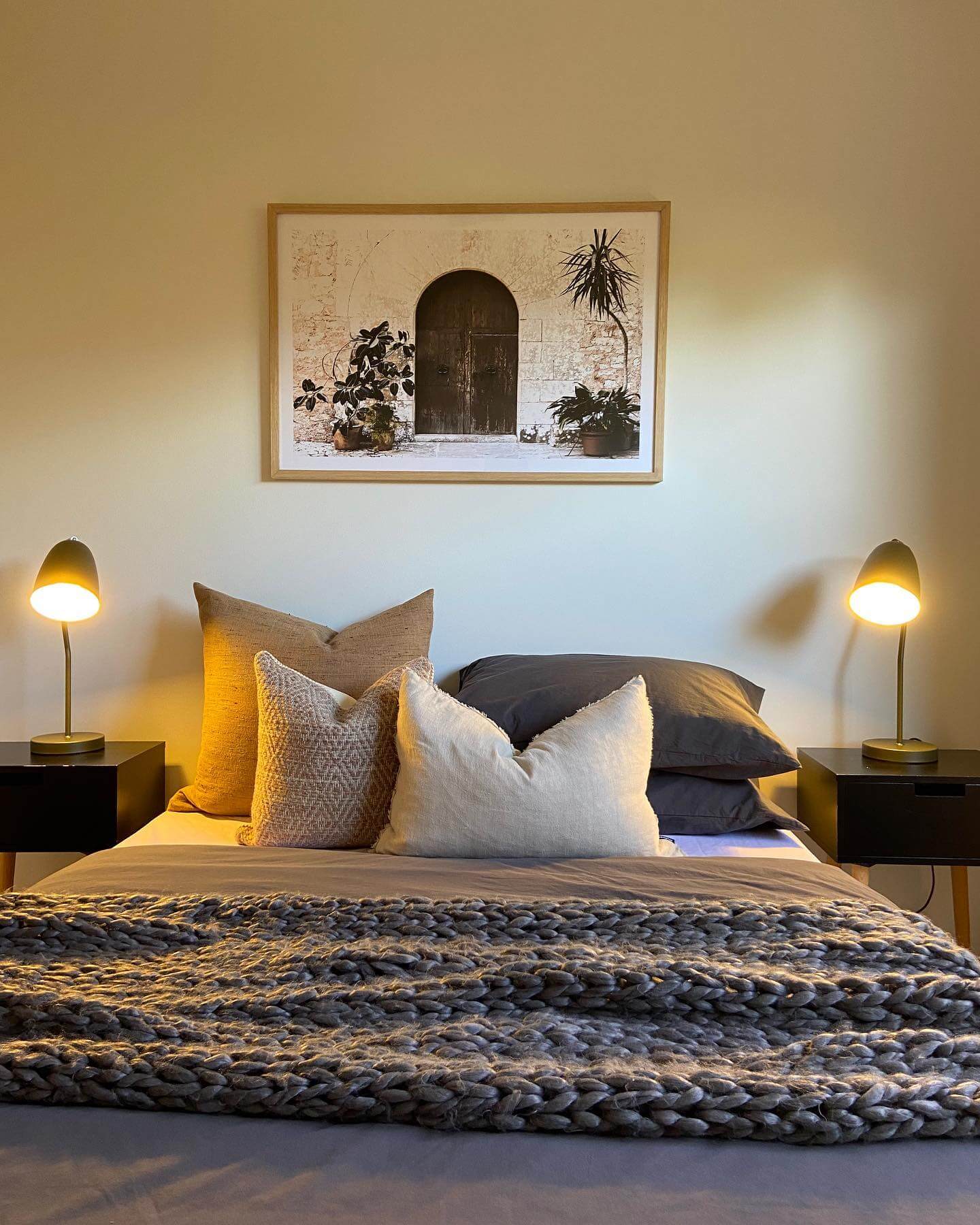 Framed Artwork Adds Rustic Charm Above the Bed
