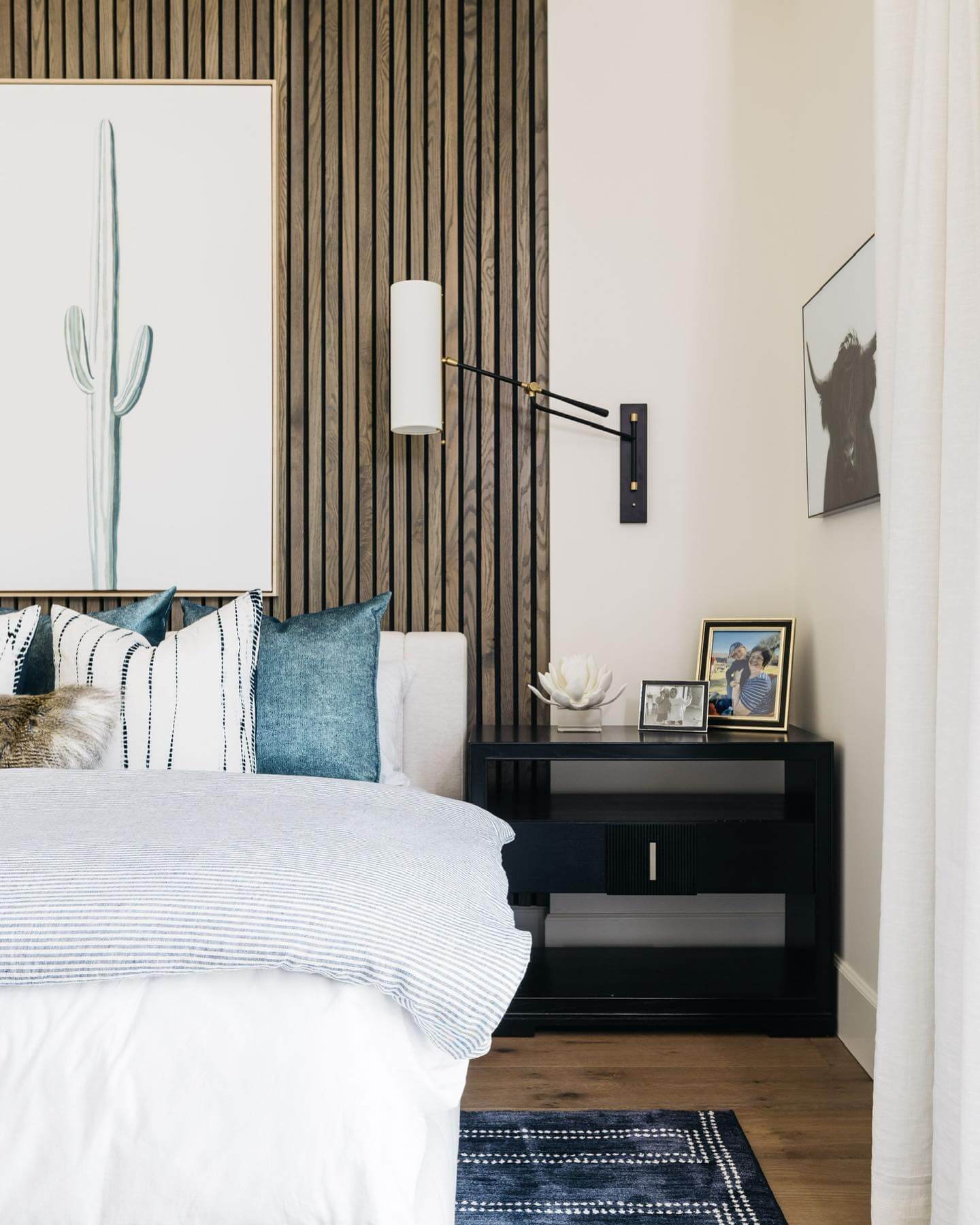 Black Nightstand Frames Personal Photos and Sculptural Decor