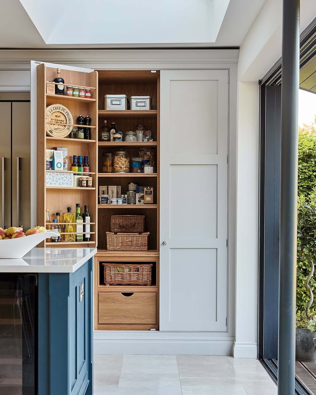 Woven Baskets Corral Pantry Goods on Open Shelves