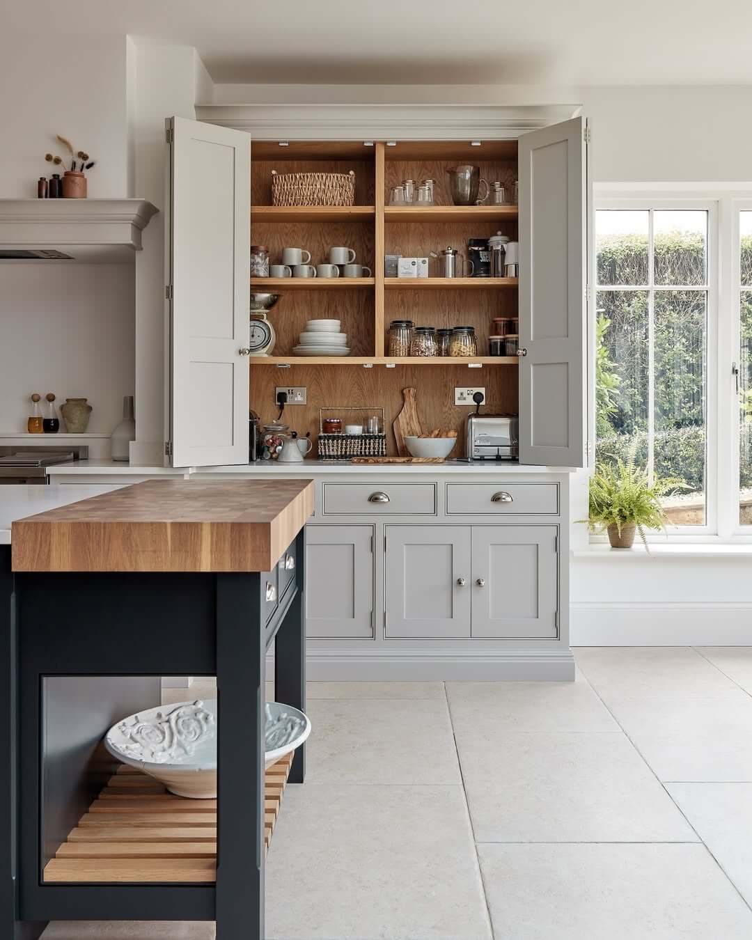 Pantry Doors Open to Reveal Natural Wood Shelving