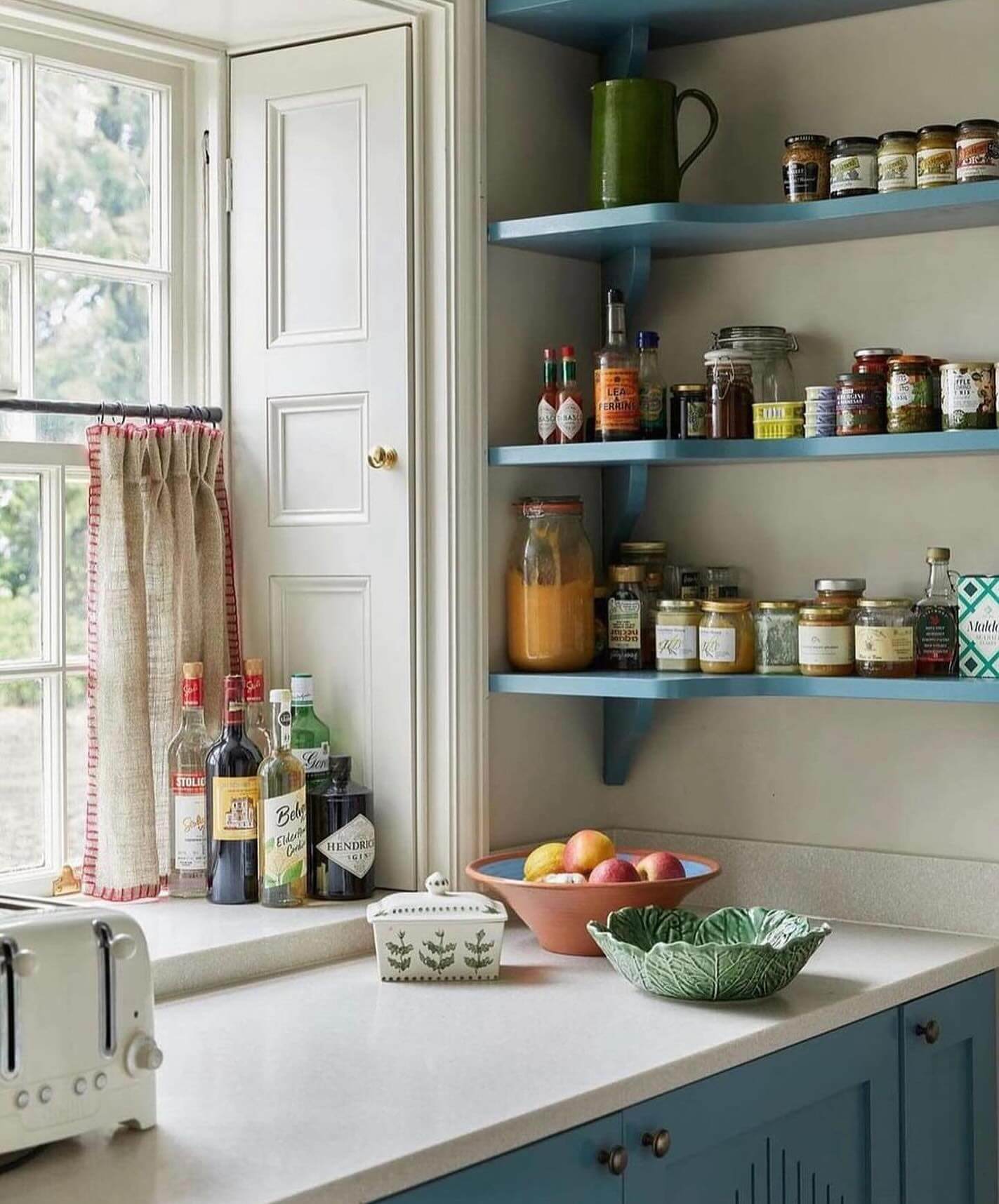Open Blue Shelving Holds Jars and Greenware