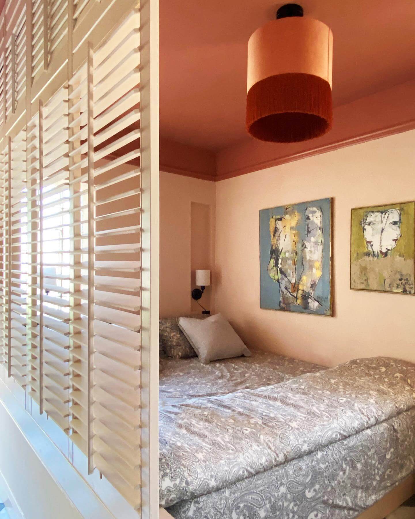 Textured Pendant Light Adds Warmth Above Peach Ceiling