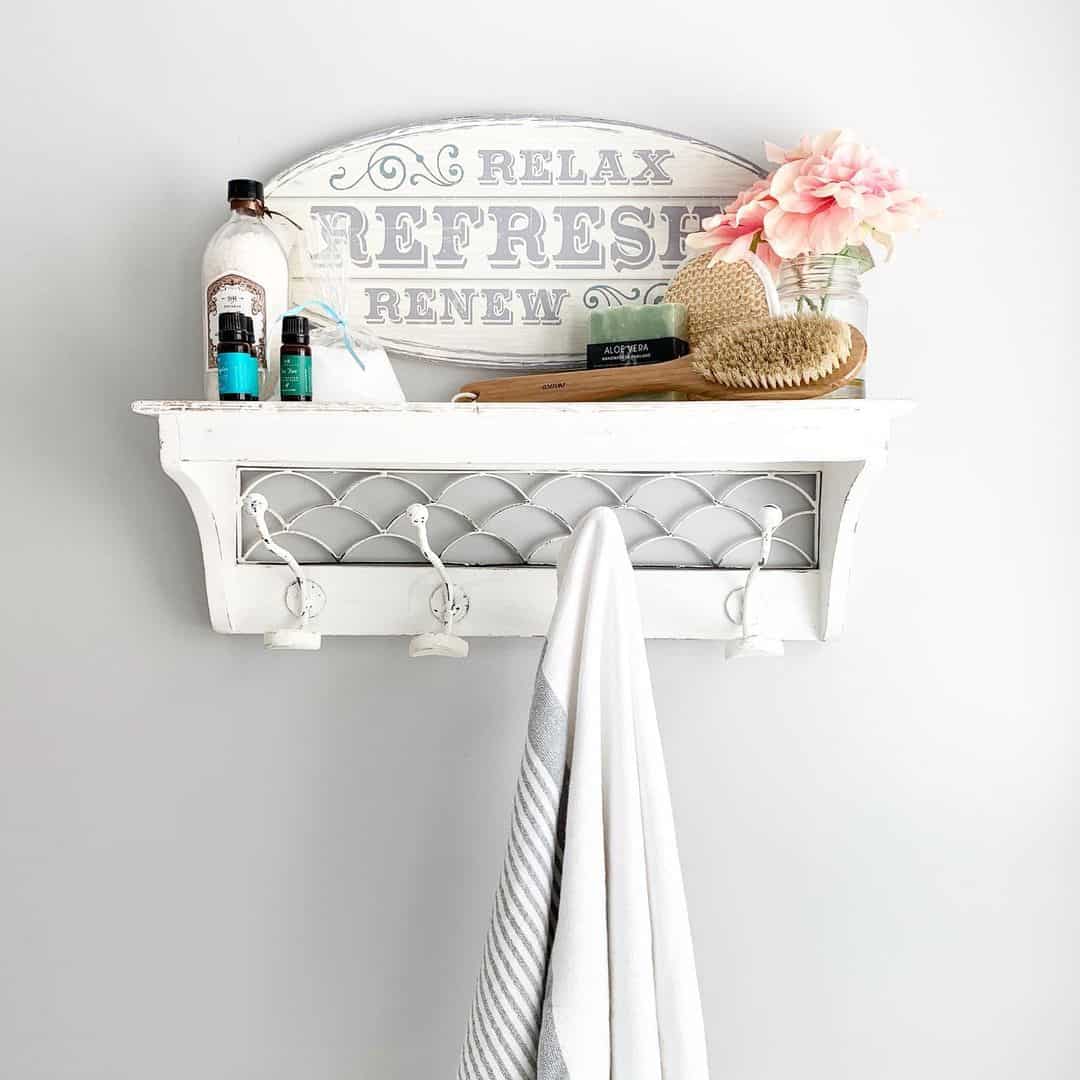 Whitewashed Shelf With Decorative Metal Inlay Holds Bathing Essentials