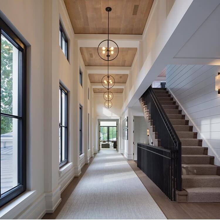 Accent Wood Planked Ceilings with Linear Chandeliers