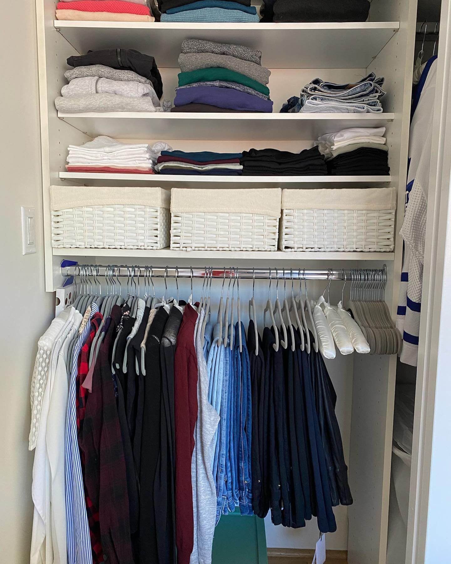 White Woven Baskets Corral Linens on Upper Shelves