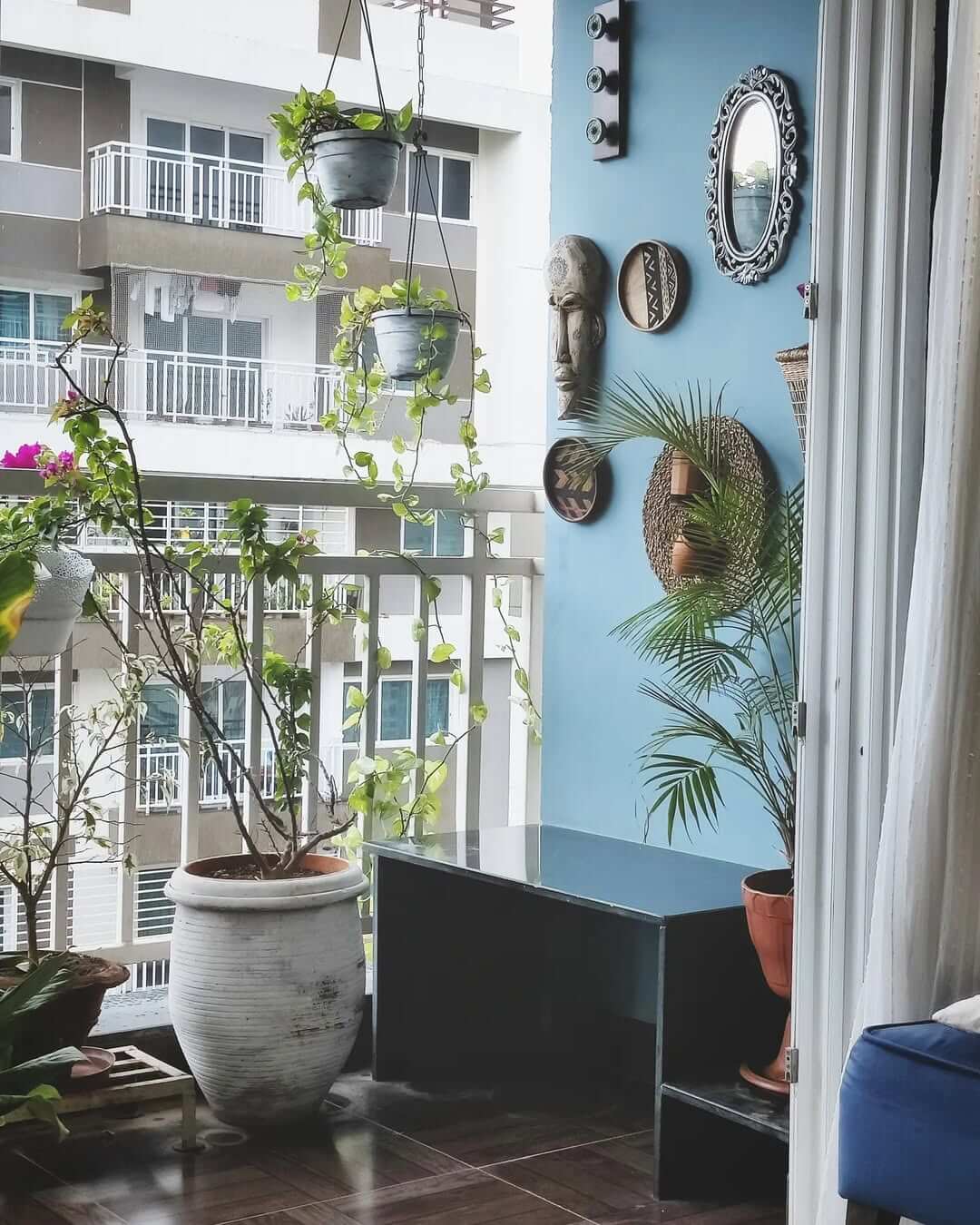 Grouped Wall Decor Creates an Eclectic Balcony Gallery