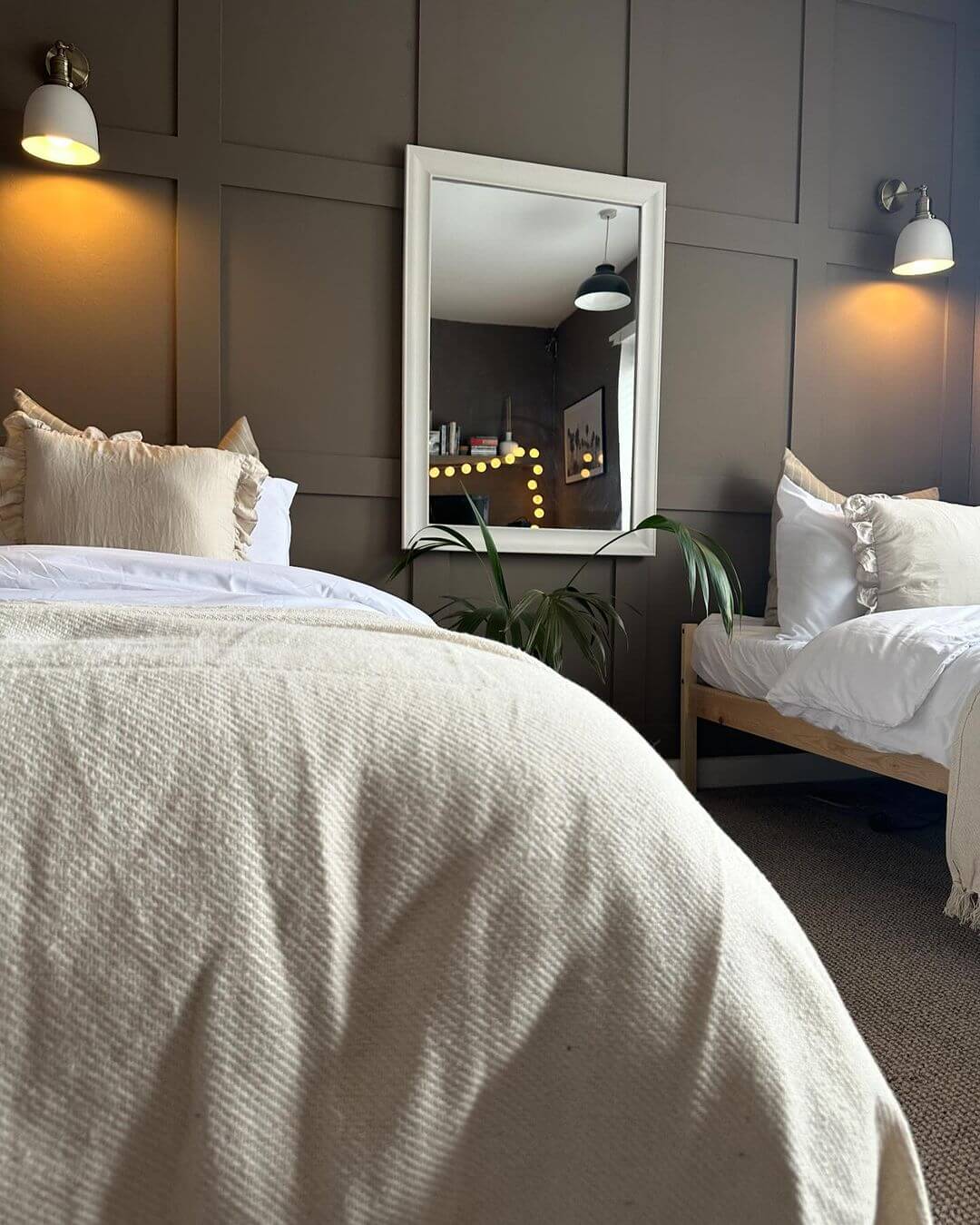 Paneled Walls Add Cozy Texture Behind Twin Beds