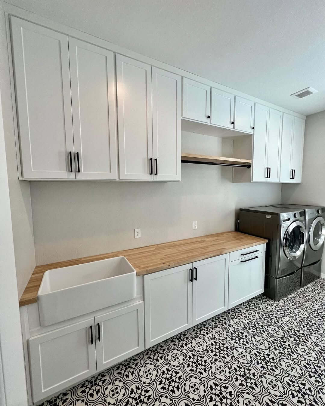 White Shaker Cabinets and Butcher Block Countertop Create a Clean Workspace