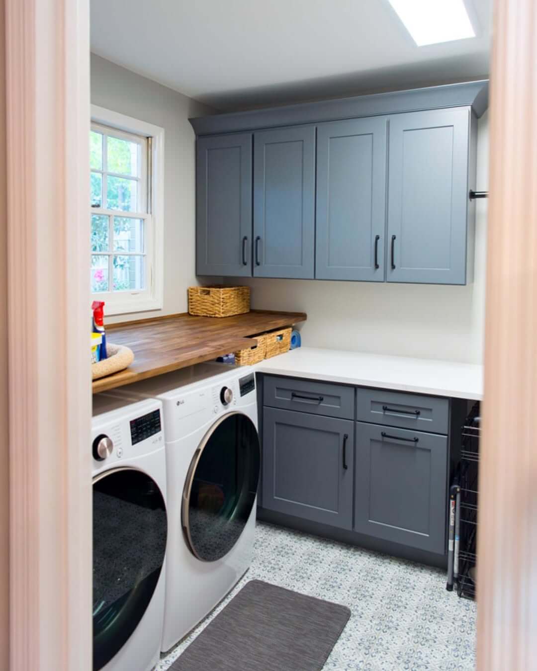 Deep Blue Cabinets Add Classic Storage Above the Washer