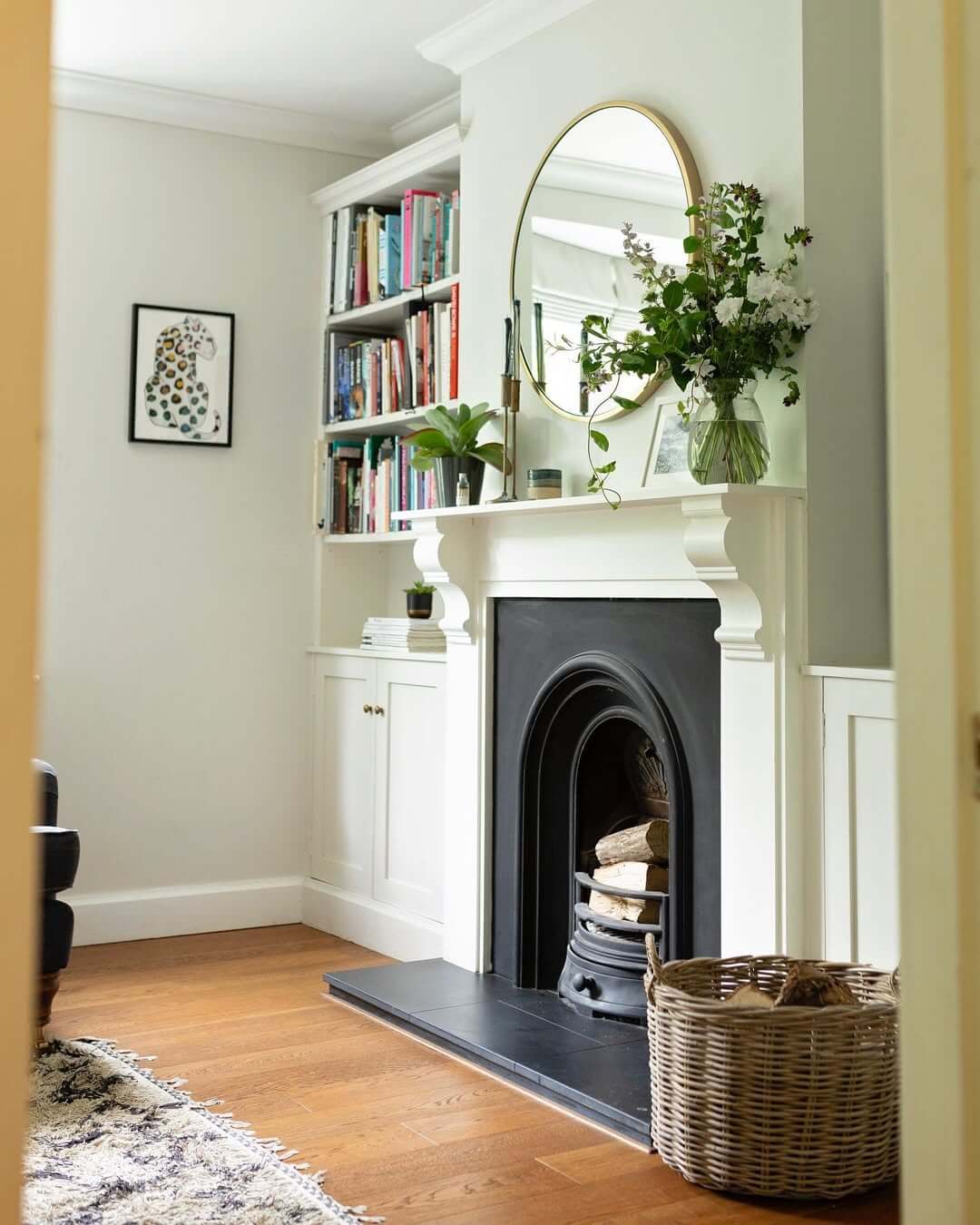 Oval Mirror with Delicate Gold Frame Above Fireplace