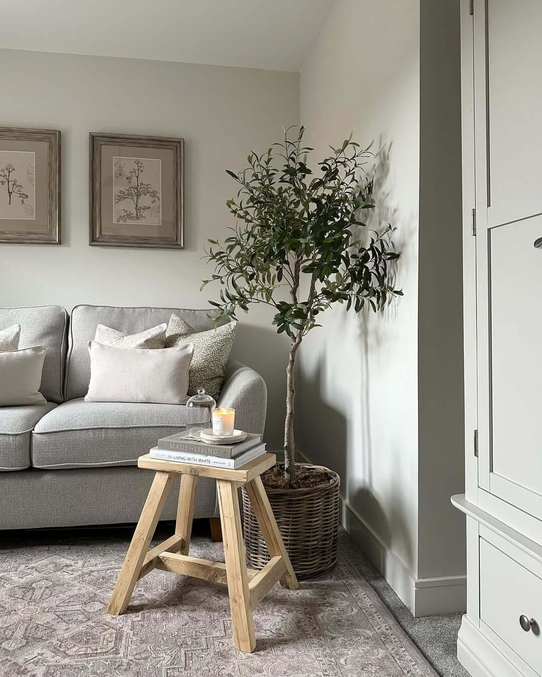 Wooden Stool Displays Books and Candle Near Sofa