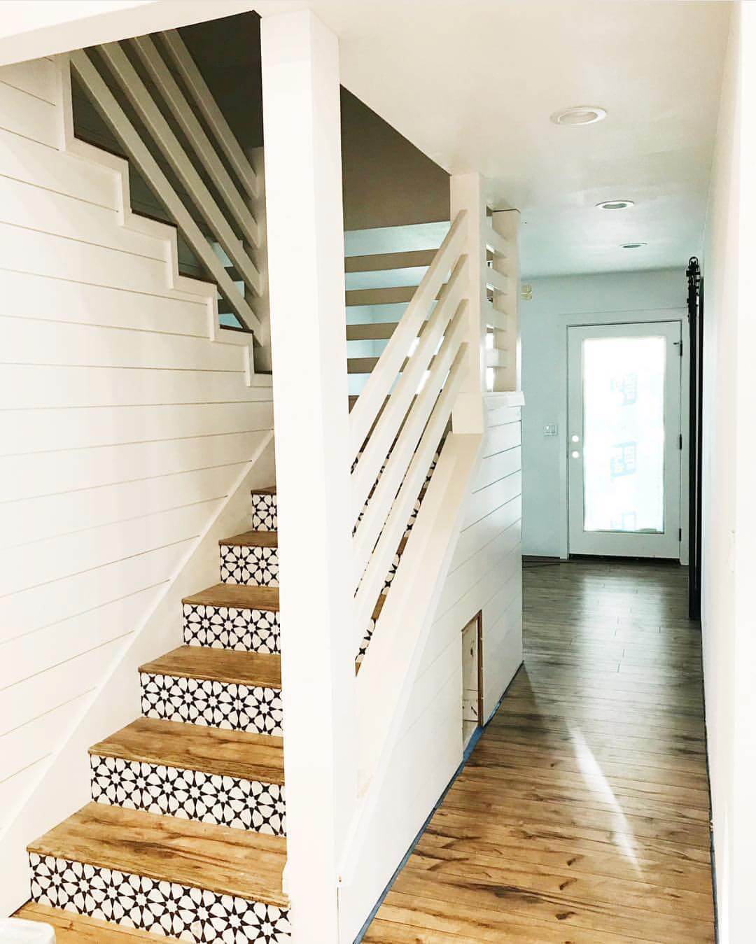 Black and White Geometric Tiles Add Pattern to Wood Stair Risers