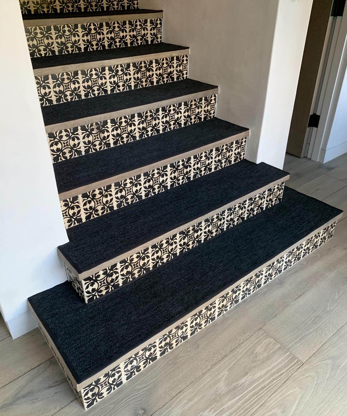 Black and White Patterned Tile Borders Frame Dark Stair Runners