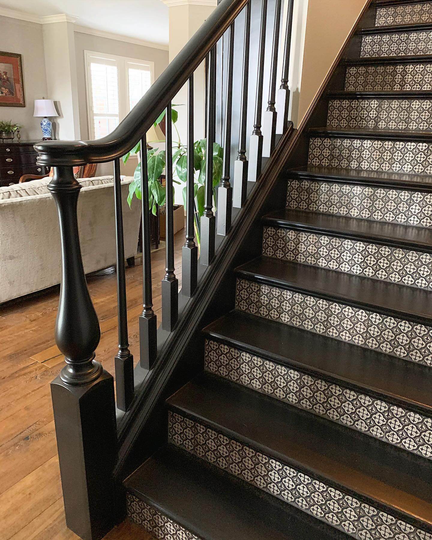 Geometric Tile Risers Add Patterned Detail to Dark Stairs