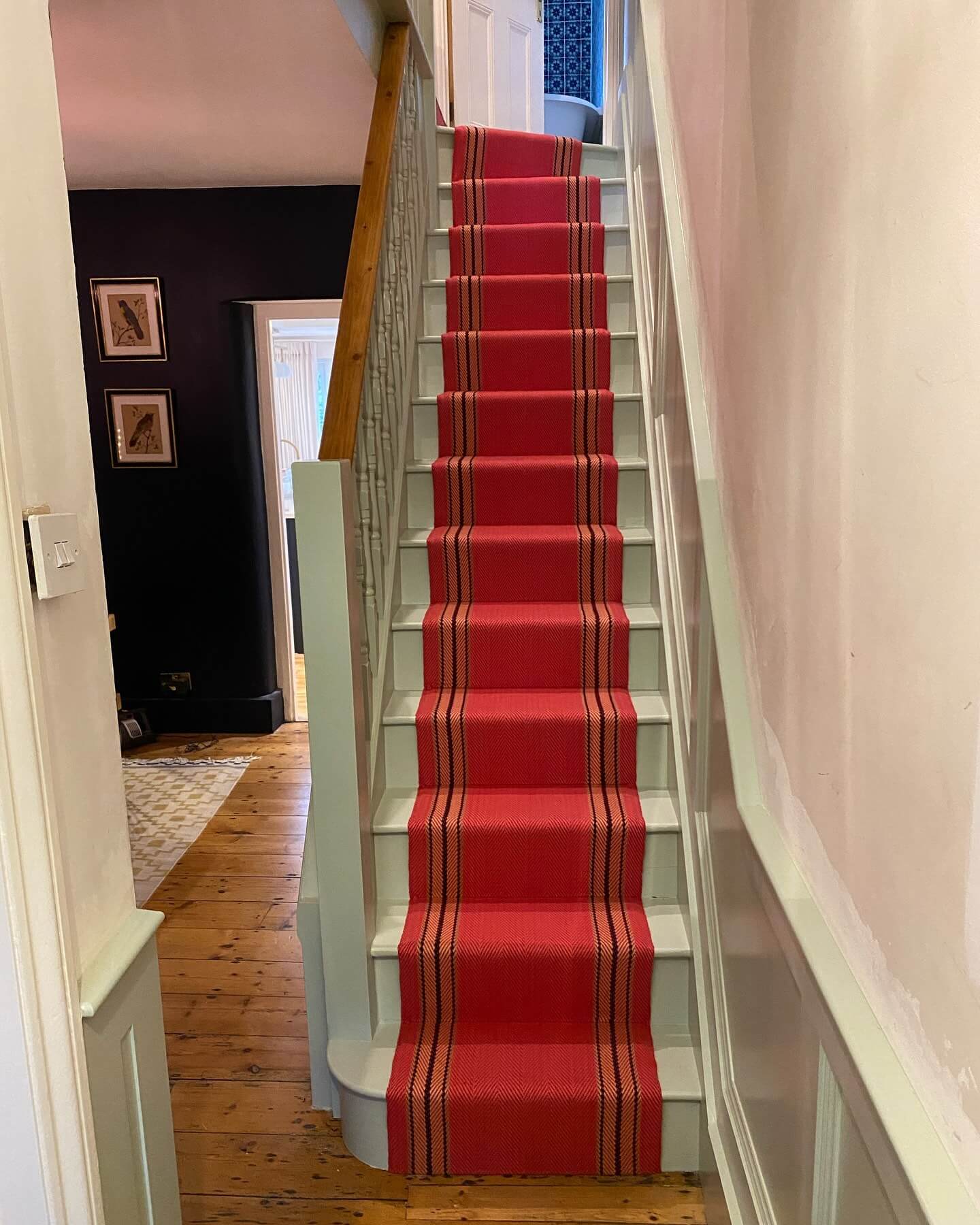 Bright Red Stair Runner With Black and Orange Stripes