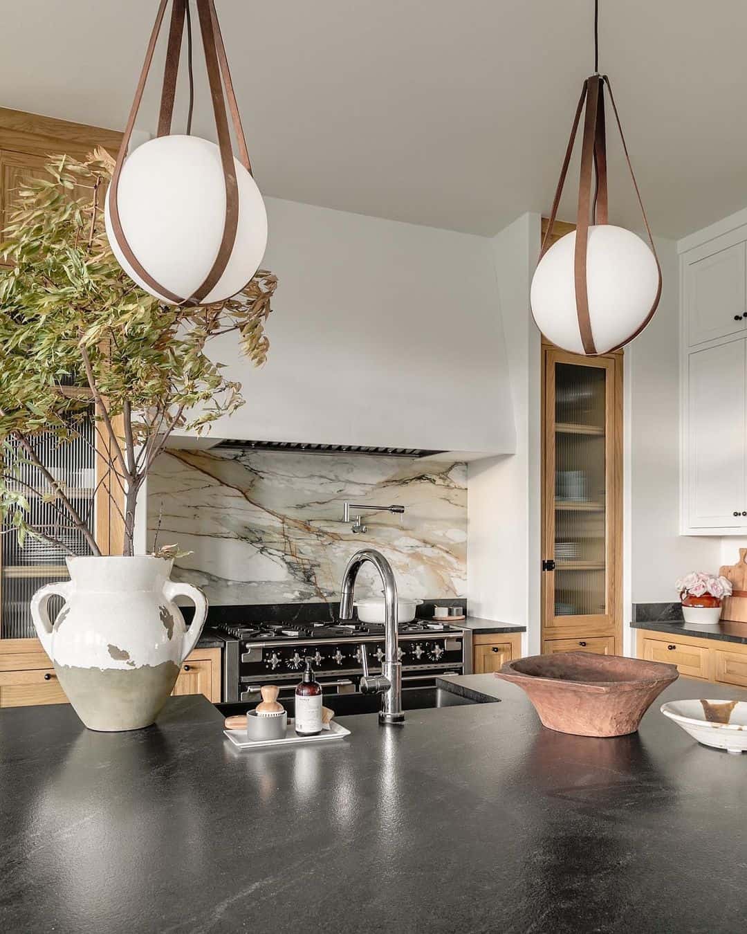 Veined Marble Backsplash Adds Dramatic Texture Behind the Stove