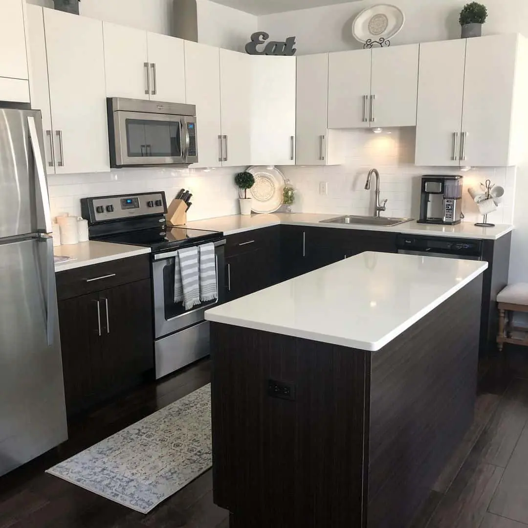White Subway Tile Reflects Light Against Dark Cabinets