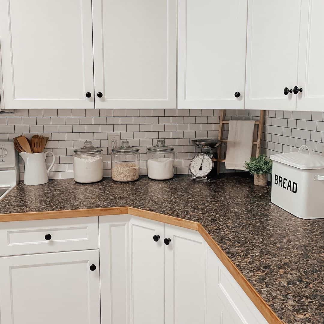 Subway Tile Backsplash With White Cabinets and Wood Countertops