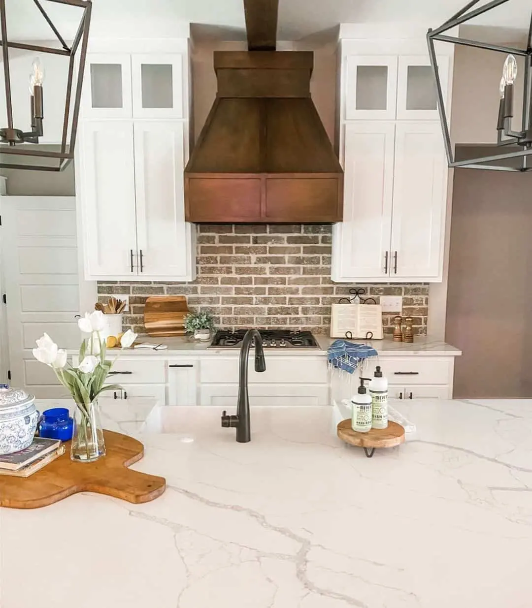 Rustic Brick Backsplash Adds Warmth Behind White Cabinets