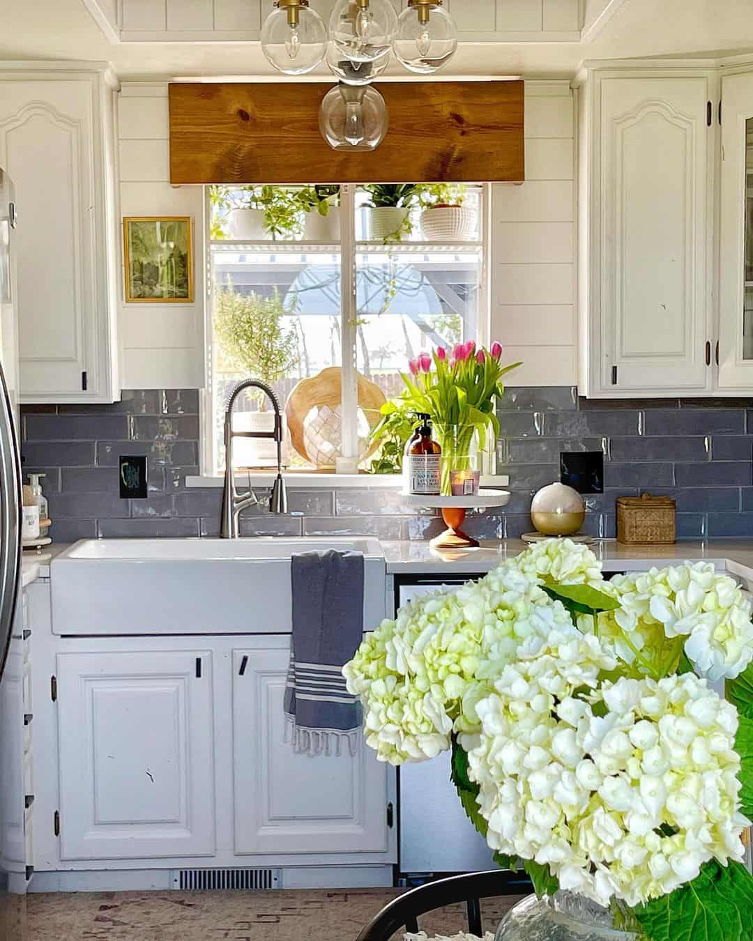 Glossy Gray Subway Tiles Add Depth Behind White Cabinets