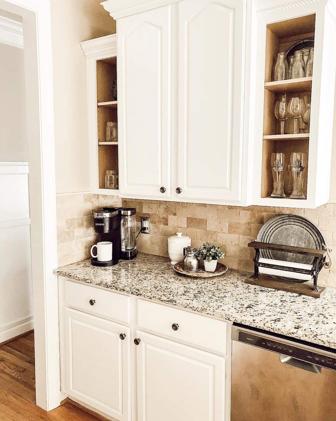 Travertine Tile Backsplash Adds Natural Texture Behind White Cabinets