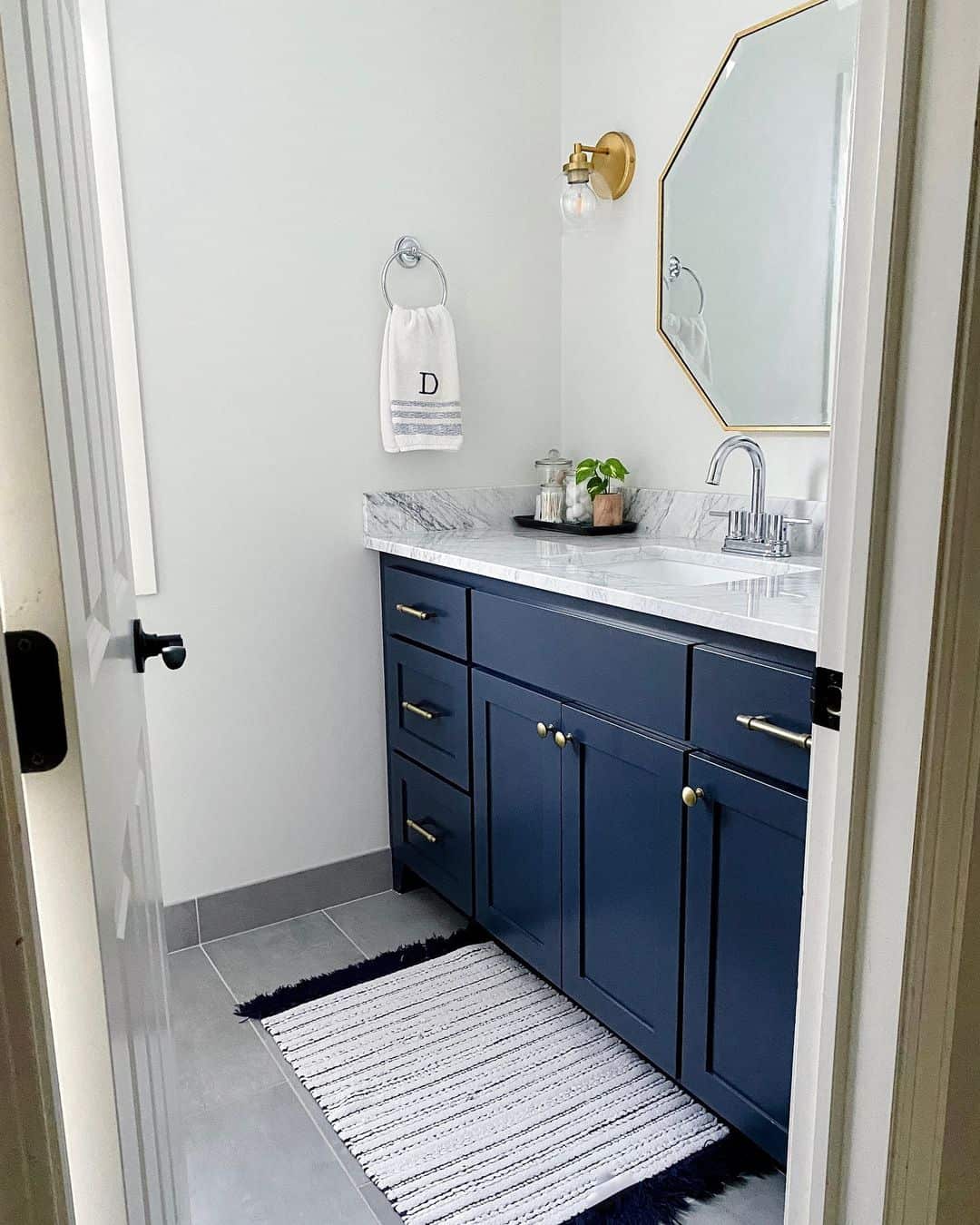 Deep Navy Cabinets with Brass Hardware Add Richness