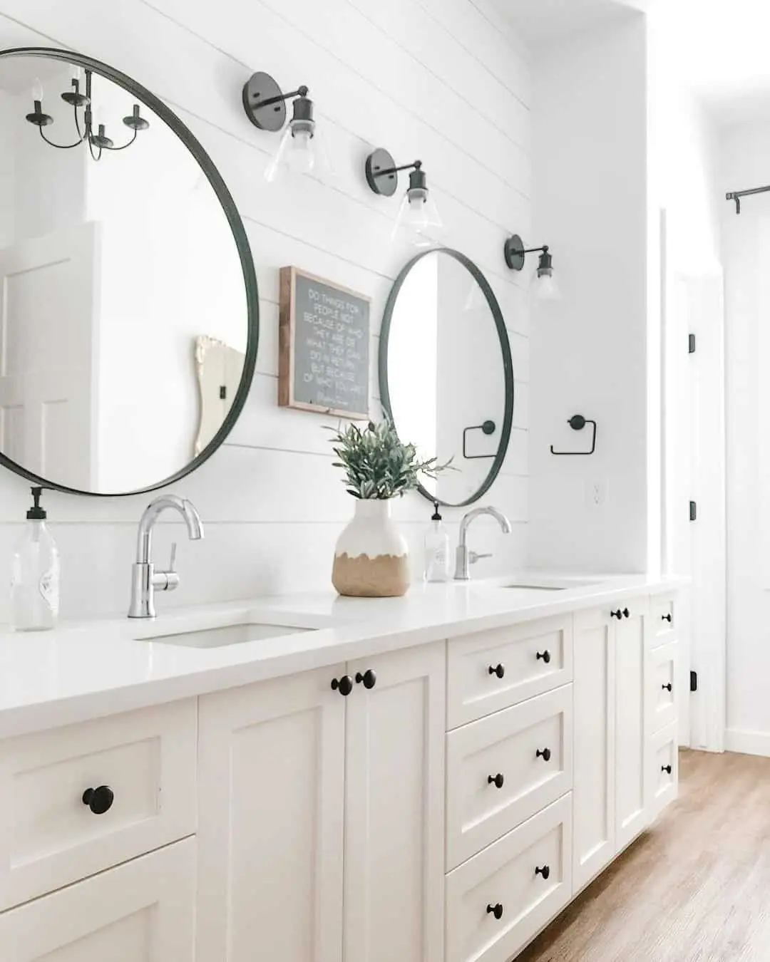 Symmetrical Round Mirrors Frame a Centered Vanity