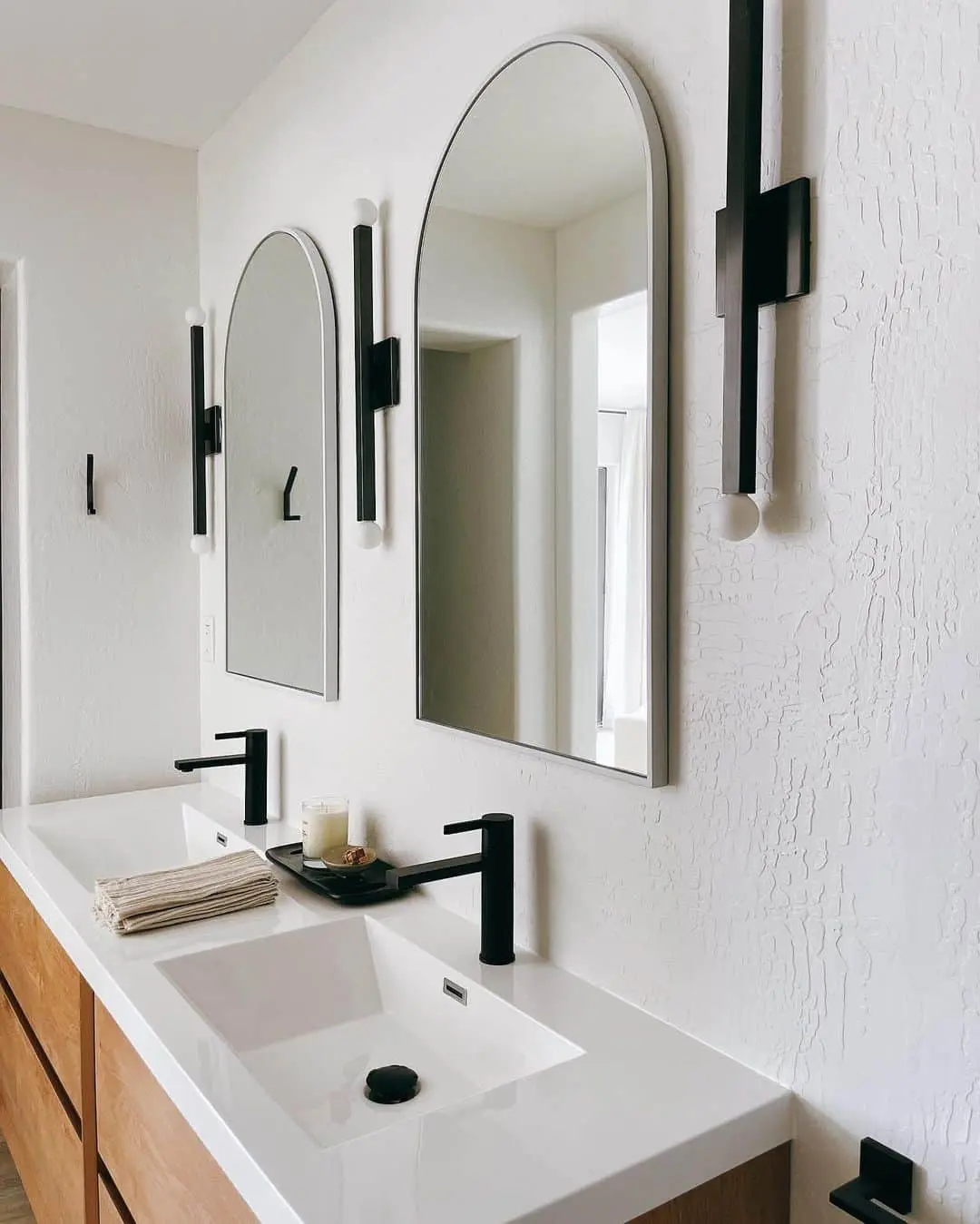 Arched Mirrors Frame Sconces Above Double Vanity